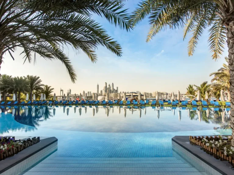 outdoor pool view of dubai skyline at Rixos The Palm Hotel & Suites - Ultra All-inclusive