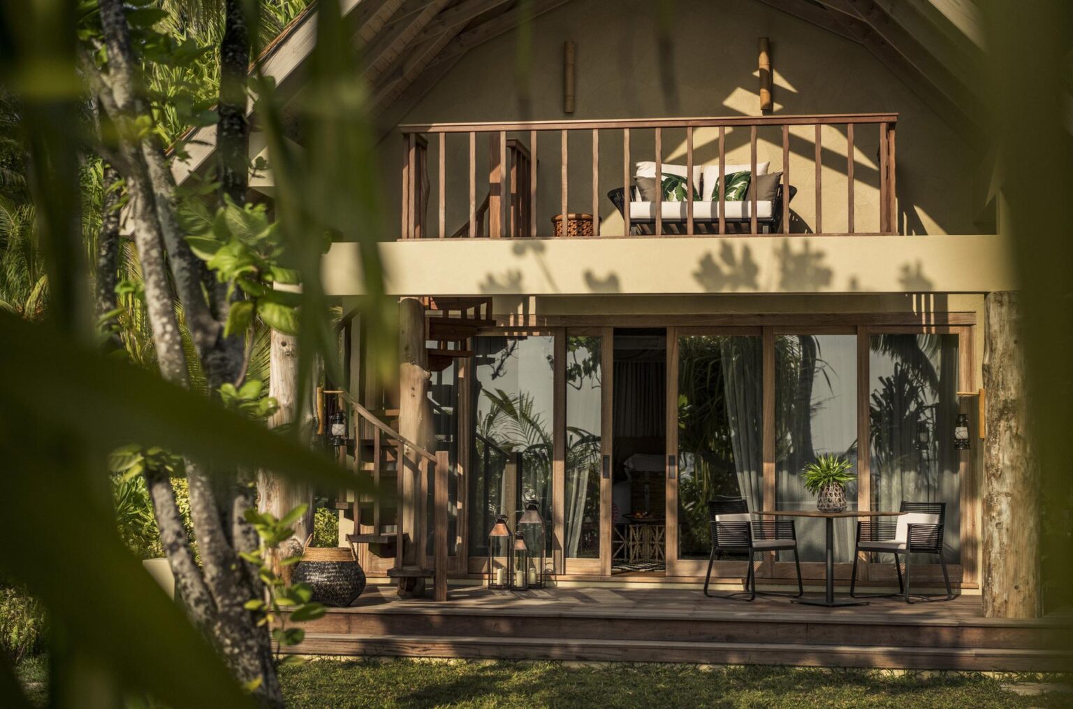 hotel z brązowym dachem wśród palm