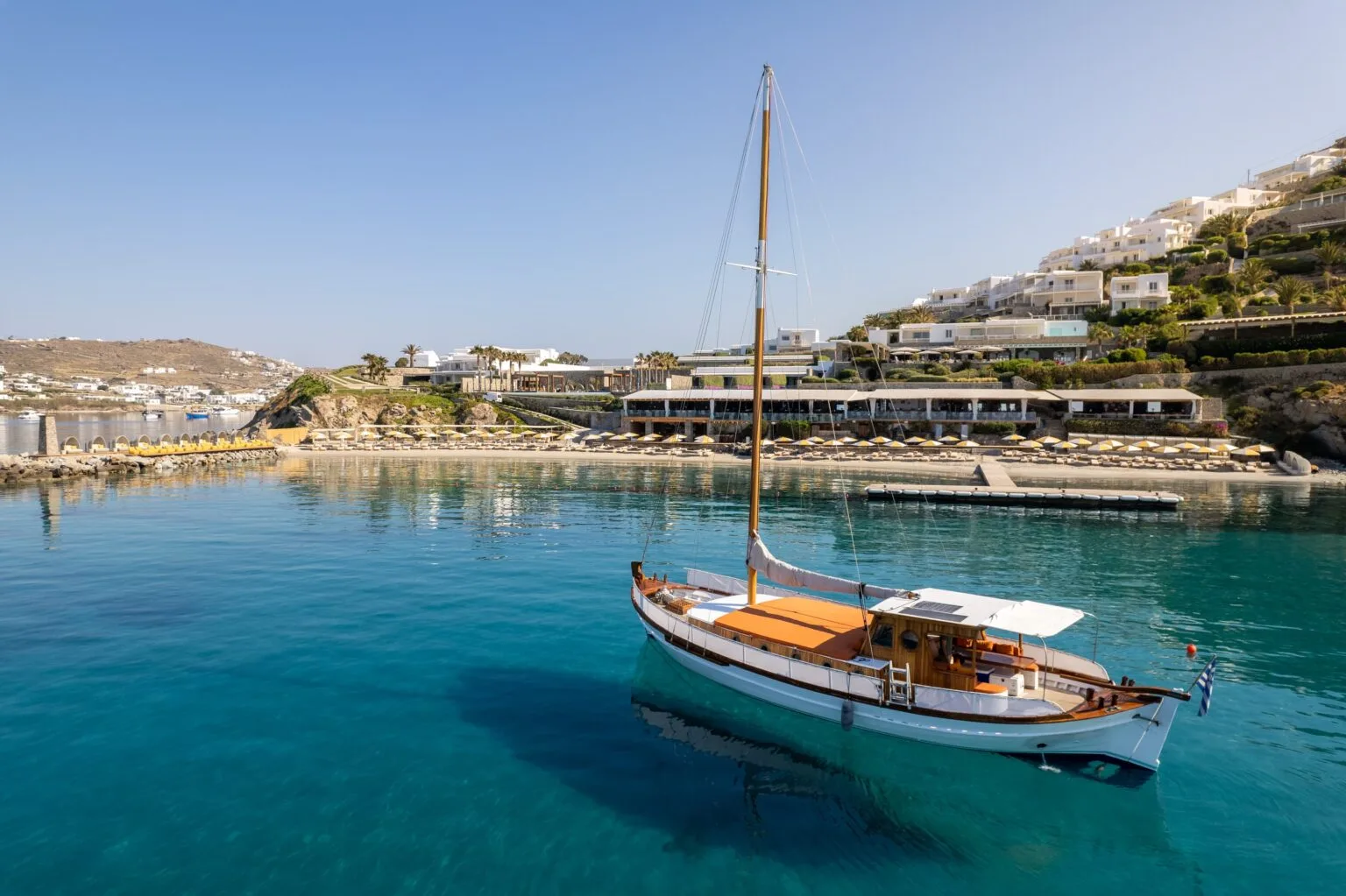view from the sea to the Santa Marina Mykonos hotel - hotel surroundings - boat in the background