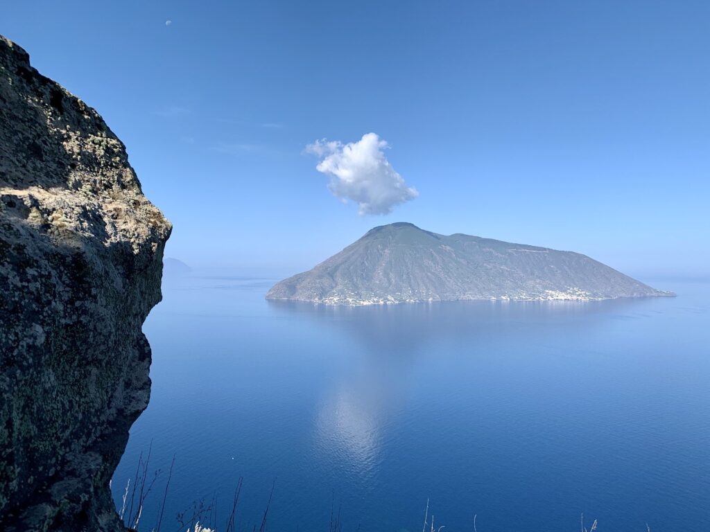 scenic view sea mountains against blue sky