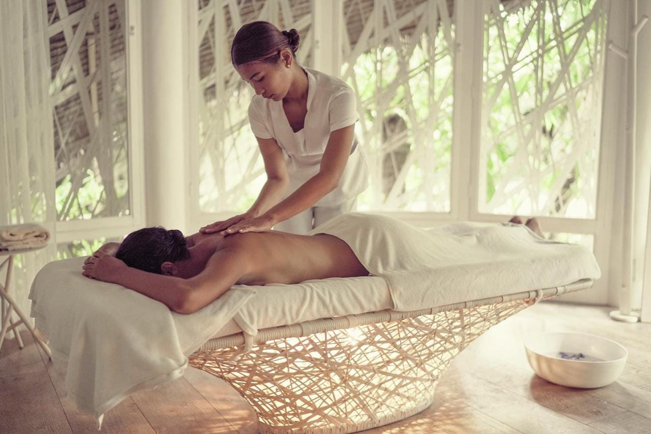 Strefa spa i wellness, kobieta wykonuje masaż relaksujący w hotelu Nay Palad Hideaway