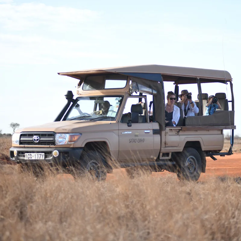 people touring in a safari vehicle