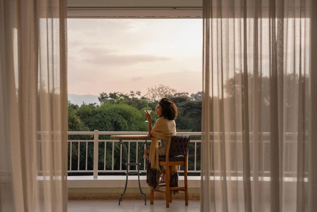 hemingways nairobi kenia kobieta odpoczywająca na balkonie z winem