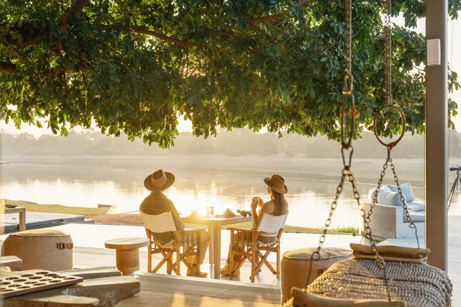 time tide mchenja zambia - a woman and a man rest in the nature by the tents