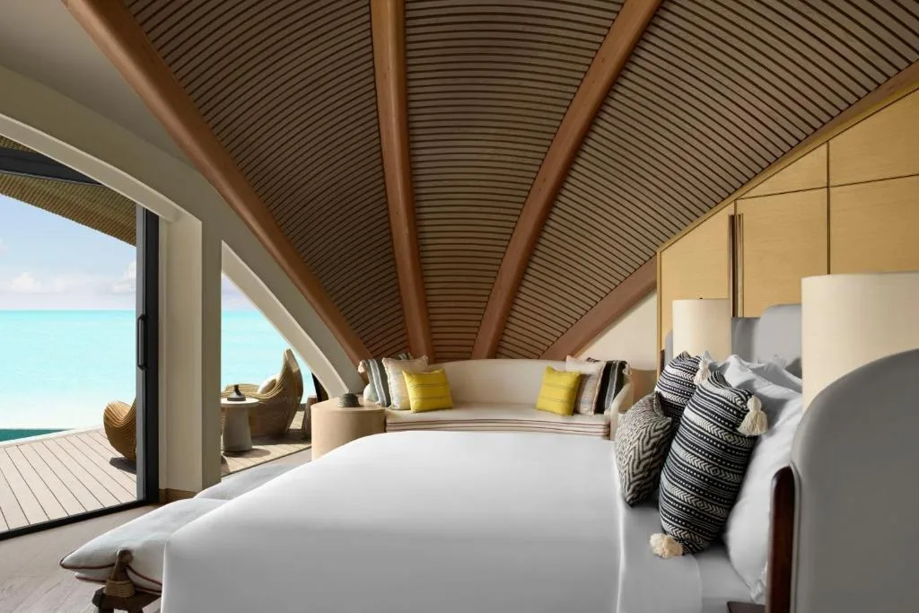 nujuma a ritz carlton reserve cottage bedroom, vaulted wooden walls, light bed