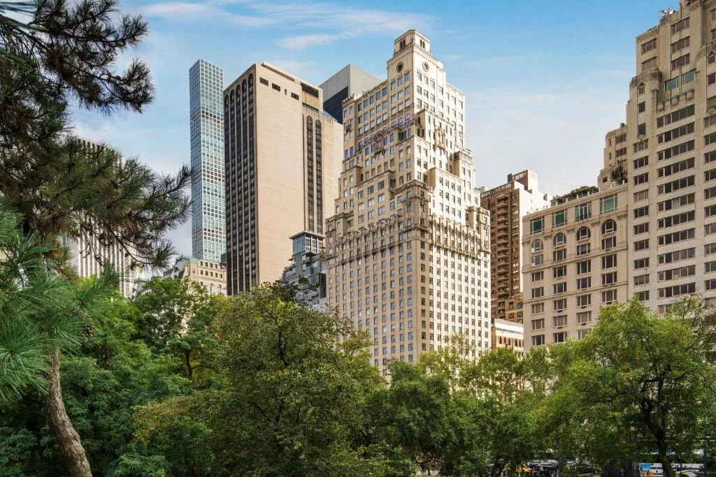 The Ritz Carlton New York Central Park building facade with trees in the background in Central Park
