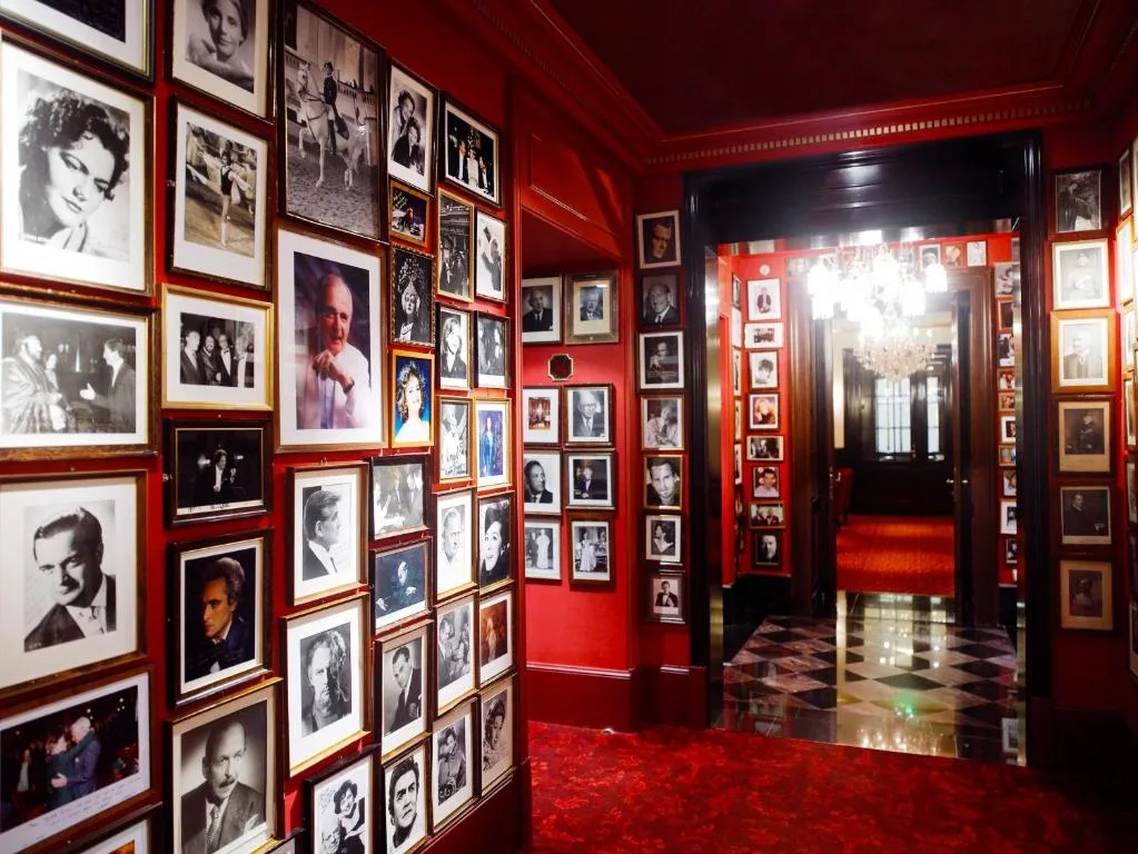 Hotel Sacher Wien hotel corridors, red walls and floor, photos of artists