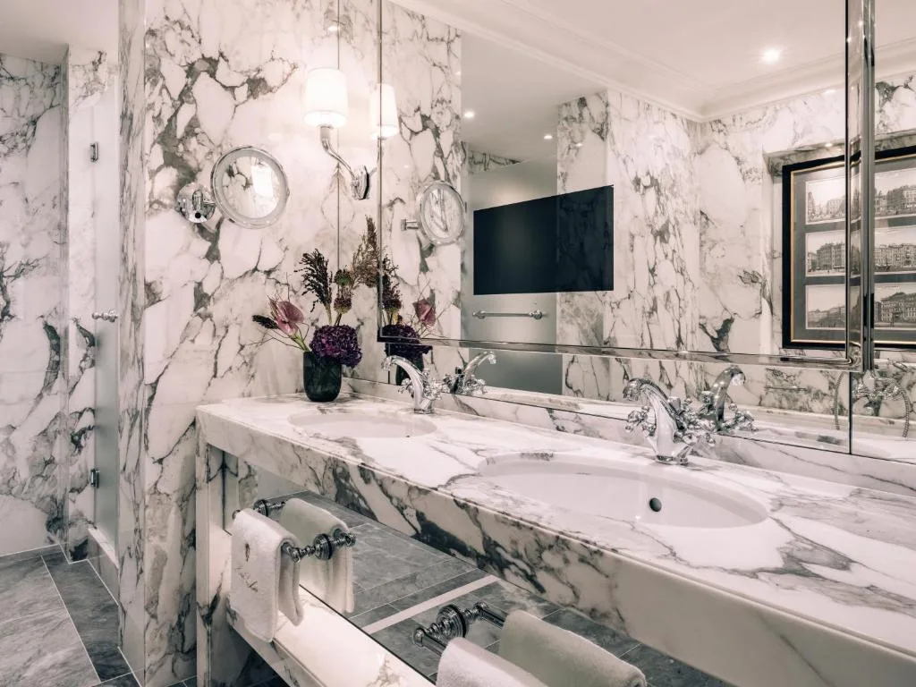 hotel sacher wien large bathroom with glass panels and silver textiles