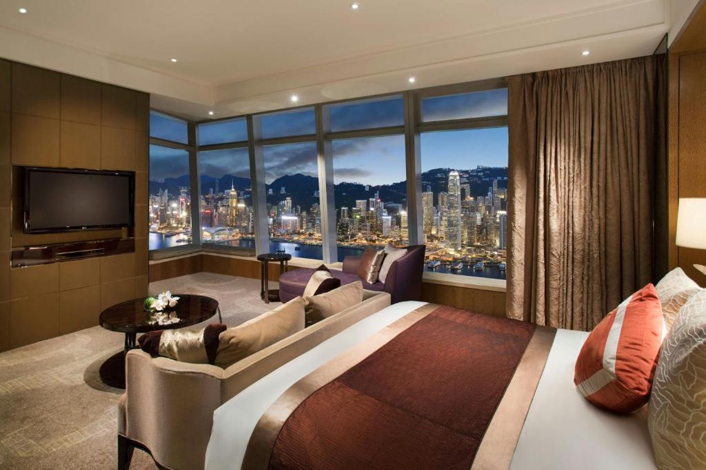 the ritz carlton hong kong sypialnia z widokiem na miasto nocą