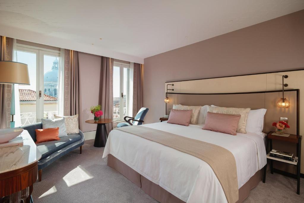 the st regis venice duża sypialnia z widokiem na miasto i fotelem