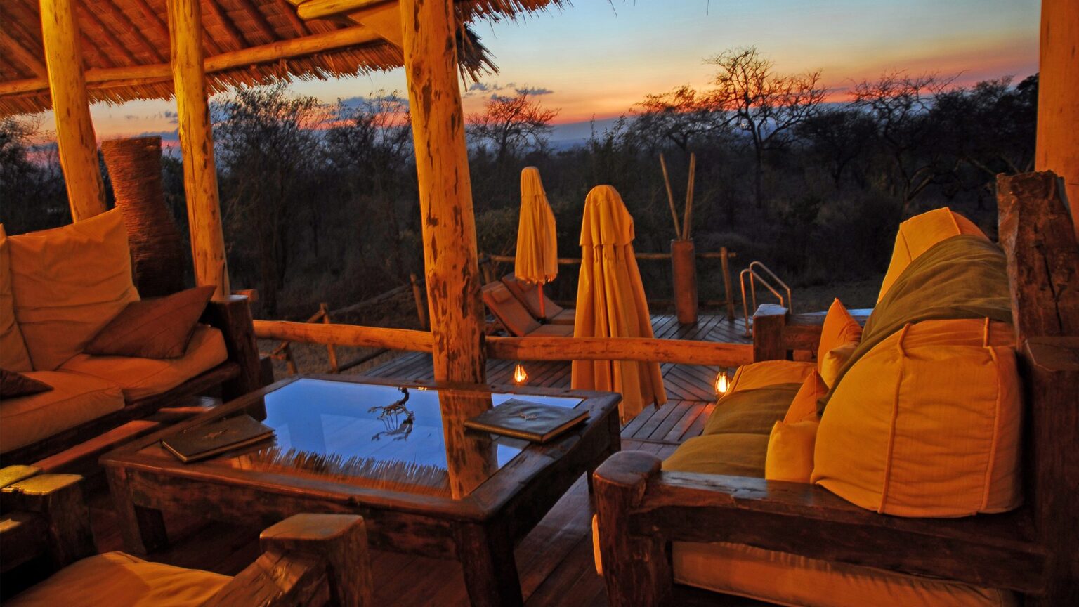 view from the main lodge across the swimming pool at sunset at tarangire tops